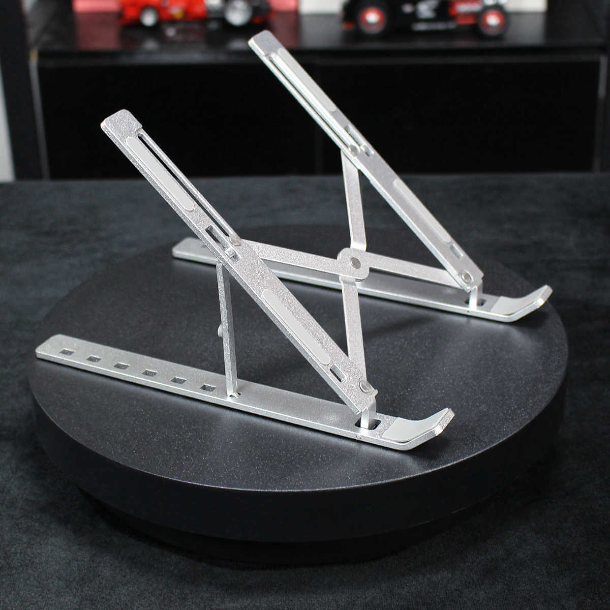 Fully extended Z34 Laptop Stand on a black surface. Sturdy aluminum construction with adjustable height settings for ergonomic use.